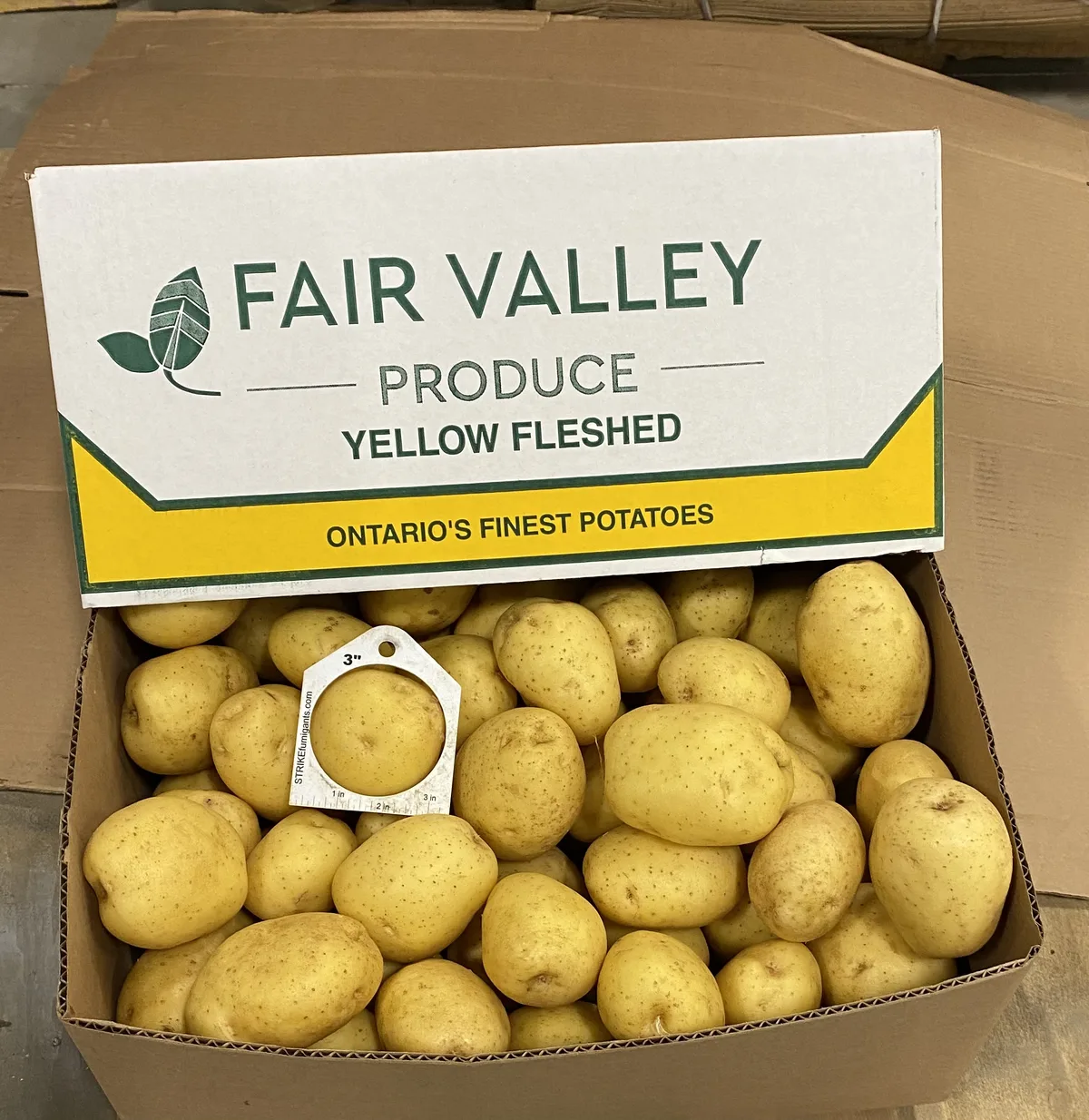 A packed Fair Valley Produce yellow-fleshed potato box